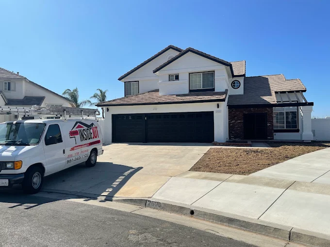 Exterior house painting contractor preparing a home